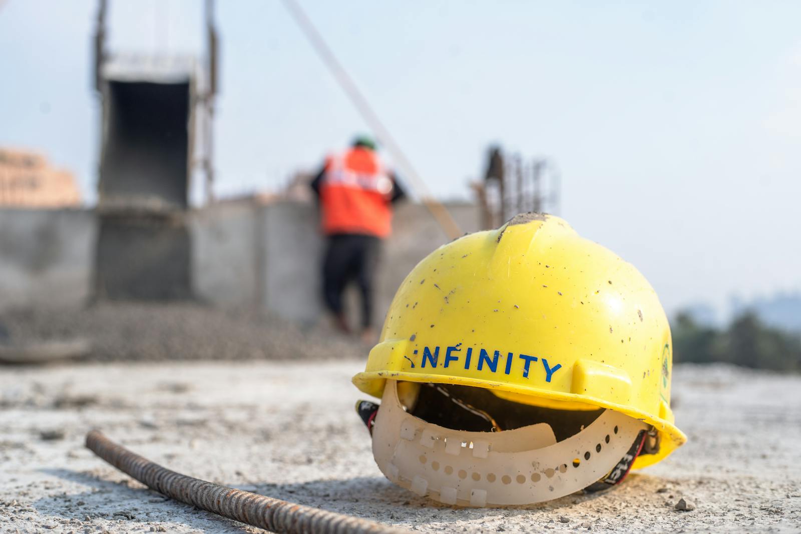 Close-up of a yellow safety helmet on a construction site in Delhi.
